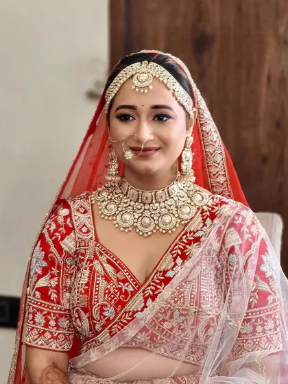 A happy bride, looking fresh and radiant. The makeup is designed to enhance her natural features, creating a look of timeless beauty.