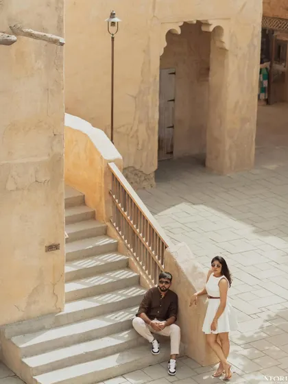 An overhead shot that captures the scale and unique architecture of the location in Dubai, with the couple as the central focus.