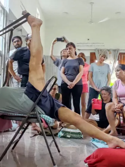 Students watch intently as I demonstrate a supported leg stretch. Observation is a key part of learning in the Iyengar tradition.