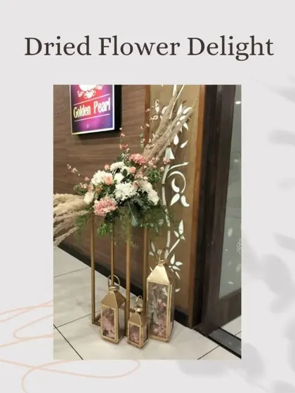 Another example of the "Dried Flower Delight" trend, this arrangement combines dried grasses with fresh flowers by an entryway, showing how to blend different textures.