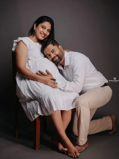 An intimate and loving pose in the studio. The partner kneeling to listen to the baby bump is a classic shot that I love to capture for its emotional impact.