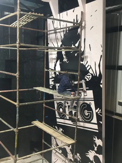 A wider view of the scaffolding setup required for a tall interior mural. We are equipped to handle projects of any height, safely and efficiently.