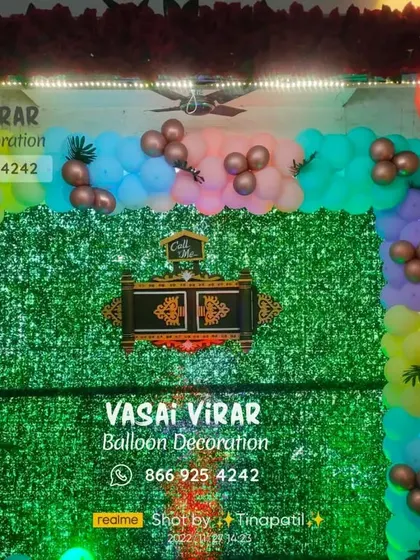 A closer look at a naming ceremony backdrop featuring a lush green wall. I added a colorful balloon border and a decorative nameplate at the center, which can be customized for your baby's ceremony.