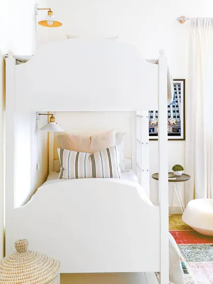 What kid doesn't love a bunk bed? For the kids' room in the JWD Marq Home, I used this classic white bunk bed to maximize space for sleepovers. The design is bright and clean, with a colorful Turkish rug to anchor the space and add a playful foundation.