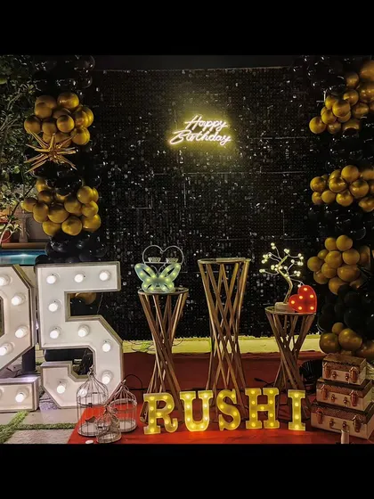 An elegant outdoor 25th birthday celebration by the pool. We used a black sequin wall, gold and black balloons, and marquee lights to create a sophisticated and memorable party atmosphere at night.