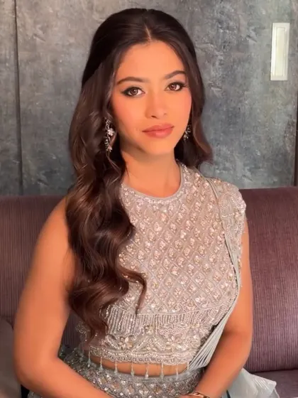 A close-up of a client in our powder blue lehenga. The sleeveless design and intricate beadwork on the blouse are perfect for a summer wedding event.