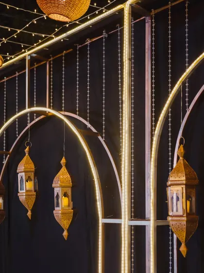 A detail shot of the Sangeet stage decor, showing the illuminated arches and intricate Moroccan lanterns that add a touch of exotic elegance.