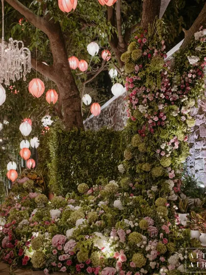 A lush floral installation around a tree for the Lagan Lakhwanu ceremony. The design seamlessly blended our decor with the natural beauty of the venue.