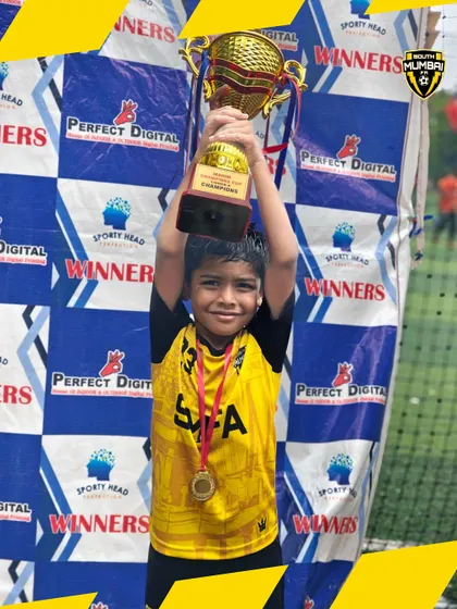 Lifting the trophy high. This U8 player embodies the spirit of victory that we cultivate at SMFA.