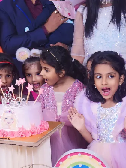 The pure excitement on a child's face says it all. This photo captures a magical moment at a Barbie-themed birthday party.
