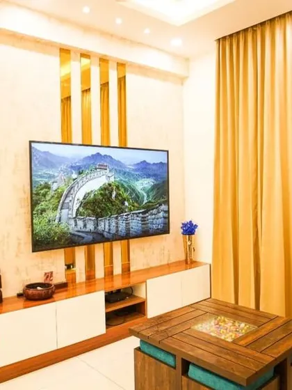 Modern luxury is all about the details. This living room showcases our ability to blend bold design choices, like the geometric gold-mirrored partition and feature wall, with comfortable, elegant furnishings for a truly glamorous result.