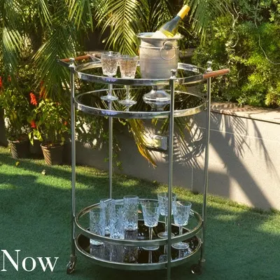 Our round bar trolley with a wood-accented handle is another great option for a mobile bar. It's pictured here in a garden setting, ready for a summer party.