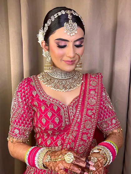 A beautiful shot of this bride's makeup. The soft pink tones on her eyes and lips, paired with a radiant complexion, create a look of pure elegance.