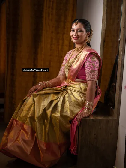 A happy and confident bride-to-be, posing for a photo before her event. Her smile shows she feels as good as she looks.