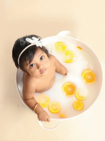 A sweet milk bath session. The simple white tub and floating orange slices create such a fresh and pure look.