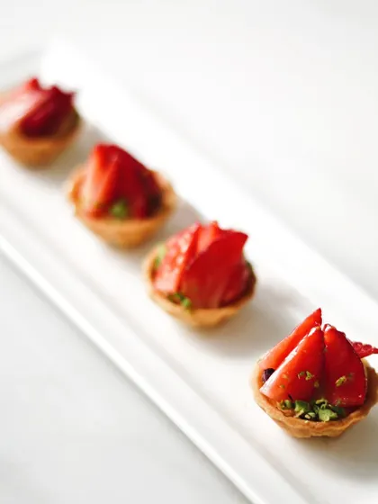 Bite-sized strawberry tartlets, ideal for parties and events. These mini treats offer the same delicious flavor in a convenient, shareable format.