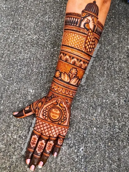 A single-arm design featuring a mix of traditional motifs like peacocks, swans, and a personalized name.