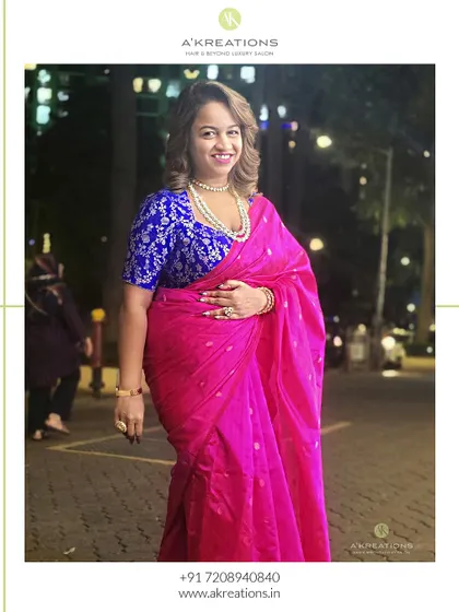 Our client looking radiant in a perfectly draped pink saree and a classic hairstyle with soft curls, ready for an evening celebration.