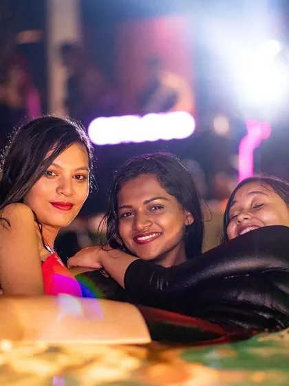 Three friends hugging in the pool, capturing a moment of pure joy and friendship.