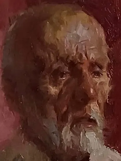 A close-up of a portrait demonstration done in Pune. The red background creates a strong contrast with the subject's face.