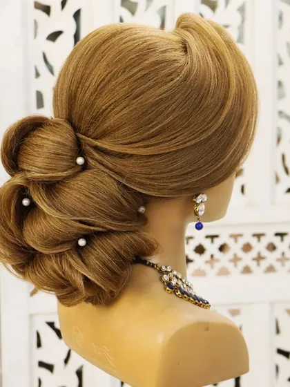 A knot element hairstyle, perfect for a reception or a gown. The intricate knots create a beautiful texture and a very secure updo that looks stunning from all angles.