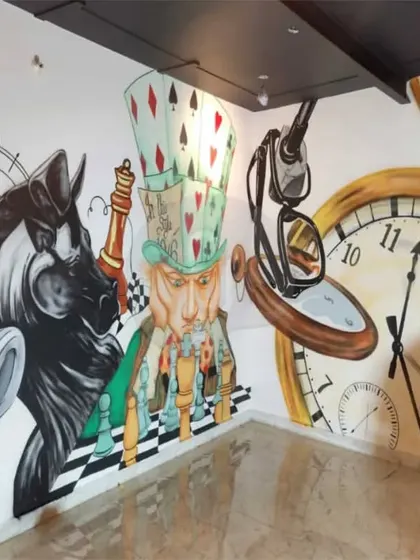 An "Alice in Wonderland" inspired mural for a client in Mathura. This surreal composition features a Mad Hatter, chess pieces, and a giant pocket watch, creating a fantastical, dreamlike scene.