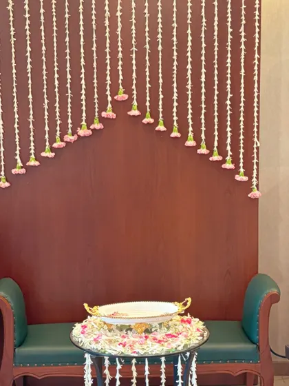 A minimalist and elegant backdrop created with delicate strings of mogra flowers. This simple design is perfect for creating a serene photo corner or highlighting a specific area in your home.