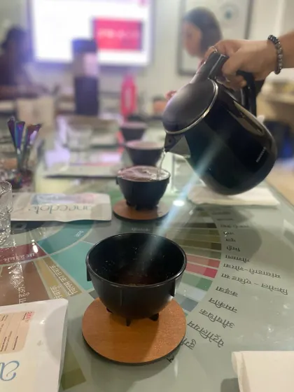 The cupping process begins with pouring hot water over freshly ground coffee. This step, known as "breaking the crust," releases the coffee's aroma.