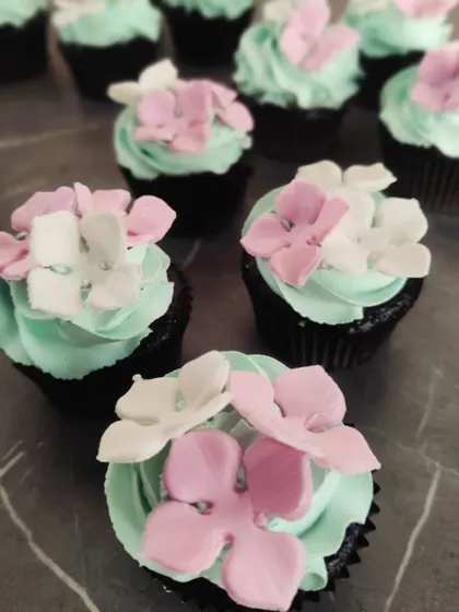 These delicate floral cupcakes were part of a Tinkerbell-themed dessert table. The mint green frosting and sugar flowers create a beautiful, enchanted look.