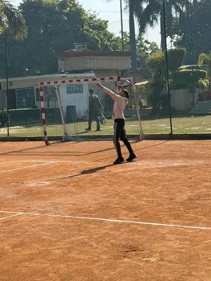 A player at the apex of his serve, demonstrating the technique we teach for maximizing height and power.