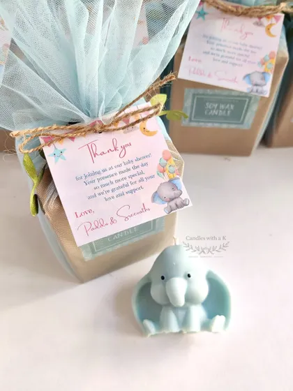 These adorable baby elephant soy wax candles were created as return gifts for a baby shower, featuring a calming light blue color and jasmine scent.