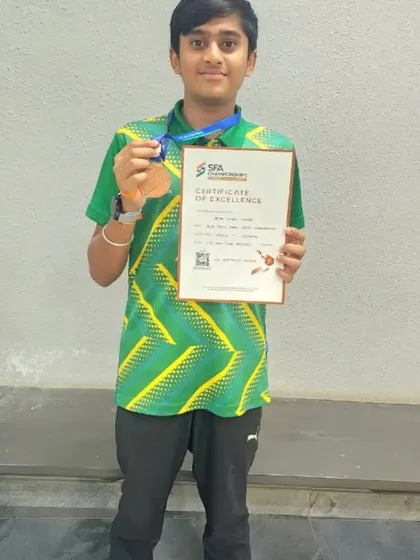 Aryan Sagar Chandra with his bronze medal and certificate of excellence from the SFA Championships in the 100m Freestyle event.