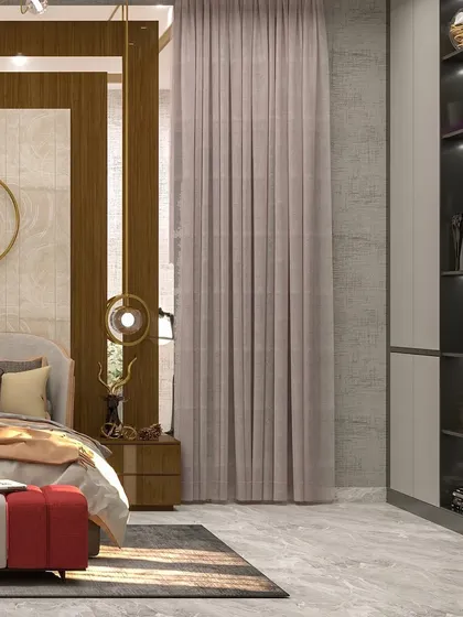 The bed is framed by a tinted mirror and wood panel, with a unique circular art piece and hanging pendant lights.
