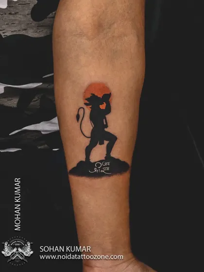 A silhouette of Lord Hanuman carrying the Dronagiri mountain, set against an orange sun. This is a powerful and minimalist way to depict a famous story, using solid black and a pop of color.