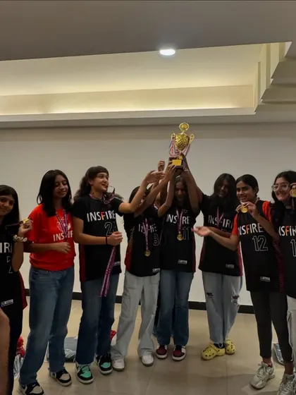 The result of discipline and hard work. Our girls' team celebrating another victory, holding the trophy high. We train to compete, and we compete to win.
