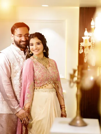 A bright and happy couple portrait from a Roka ceremony, with a beautiful lens flare adding a touch of magic.