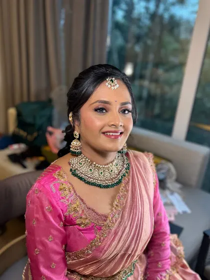 A happy, smiling portrait of Shivani during one of her wedding events. The makeup is fresh and radiant, letting her joy shine through.