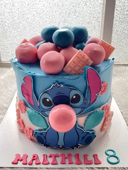 A cute and mischievous Stitch cake. I used different shades of blue and pink to capture his look, complete with a big bubblegum bubble.