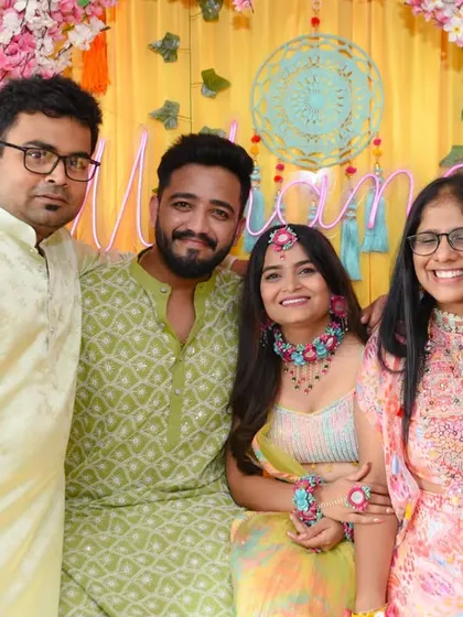 A smaller group of close family and friends posing with the couple.