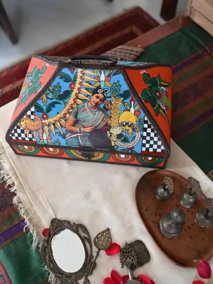 A wider shot of the pyramidal memory box, showcasing its unique shape and the beautiful artwork that adorns its surfaces. It's a piece of heritage-inspired decor for the modern home.