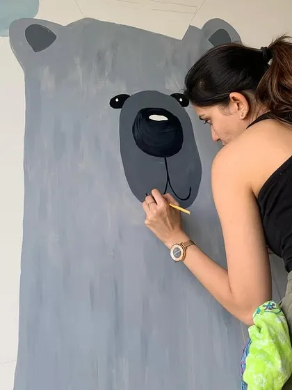 A close-up of me painting the friendly bear's face. Getting the expression just right is key to making the character feel gentle and approachable.