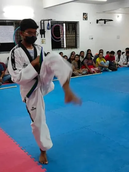 A senior student demonstrates a kick during his belt exam.