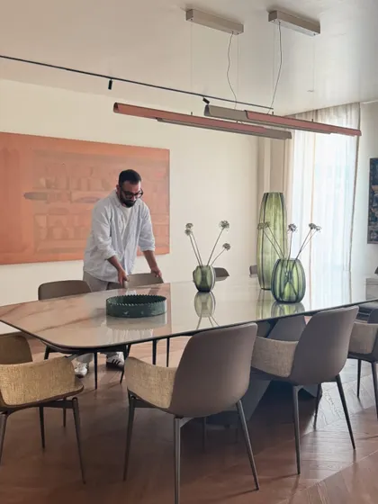 Here I am, making final adjustments to the dining room setup. This behind-the-scenes shot reflects our hands-on approach and the belief that great design requires empathy and a deep connection with the space and the people who will use it.
