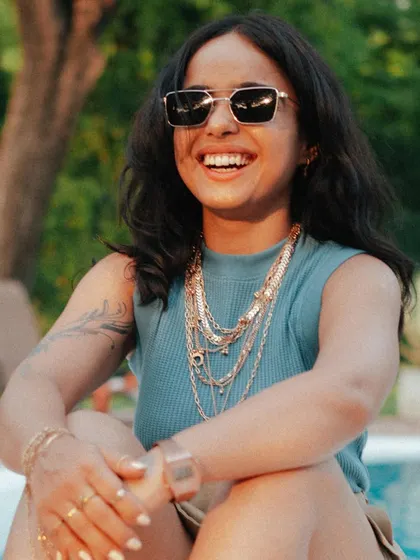 A big smile and lots of gold chains. This captures the fun, "Gangsta Bappi Lahiri" vibe I was going for in this shoot, showing that I don't take myself too seriously.