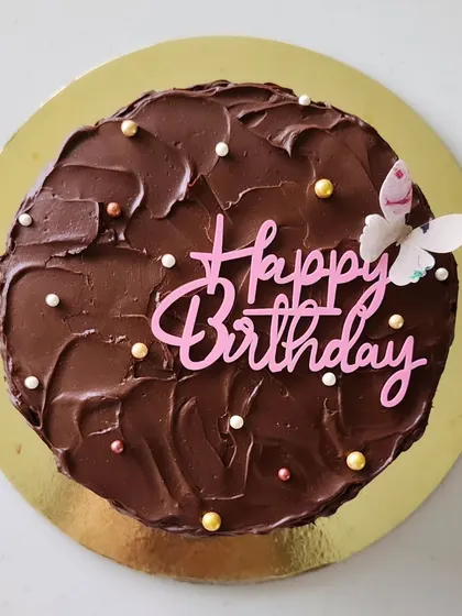 For those who prefer eggless options, I offer this delicious eggless chocolate cake. It’s filled with a fresh strawberry compote, covered in dark chocolate ganache, and decorated with a butterfly for a delicate touch.