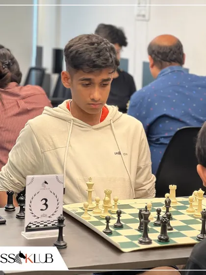 A teenage player analyzes the board during a competitive match, highlighting the strategic depth of the game.