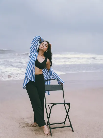 A standing pose with the chair, creating strong lines and a powerful silhouette against the moody sky.