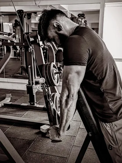 A tricep pushdown, a key exercise for building balanced and powerful arms.