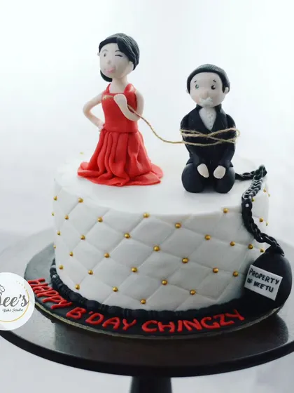 A hilarious cake for a bachelor party. This cake features a fondant bride tying up her groom, a playful take on "tying the knot."