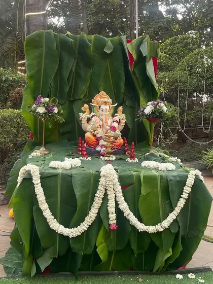 A beautiful Ganesha idol decorated with banana leaves and traditional flower garlands. Placing a Ganesha at the entrance is a wonderful way to welcome guests and bless the occasion.